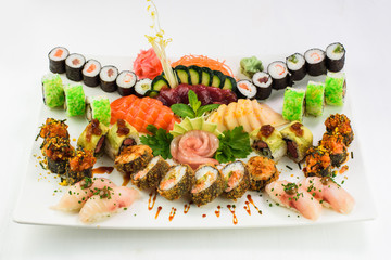Colorful Sushi Set and sushi rolls served on white background