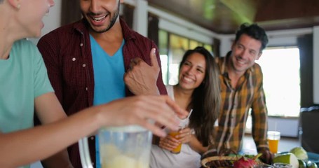 Young Man And Woman Use Blender Prepare Healthy Smoothie People Group Talking Two Couples In Kitchen Cooking Together Slow Motion 60