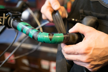 Guy fixing rudder of bicycle