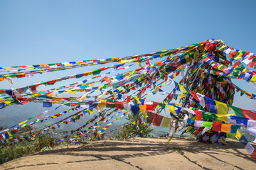 Colorful prayer flag mountain near ancient and holy Namobuddha monastery. Dhulikhel, Nepal.