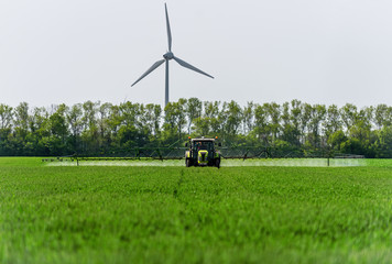 Agricultural tractor is spraying pesticides.