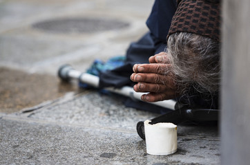 Homeless elderly woman refugee  in a street