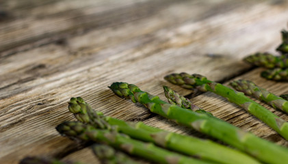 Brunch of Fresh Asparagus on vintage wooden background. place for text