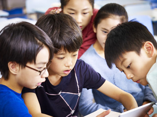 group of asian pupil using tablet together