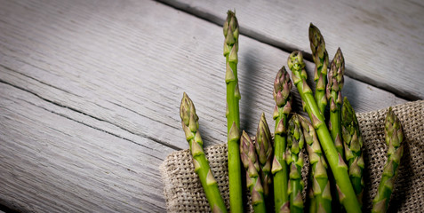 The Brunch of Fresh BIO Green Asparagus  on vintage wooden background. place for text