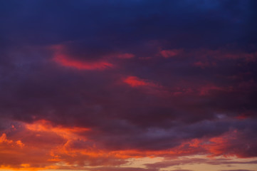 Sunset with clouds, in orange and purple shades