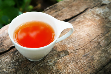 Cup of tea on wooden background in sunny morning with copy space