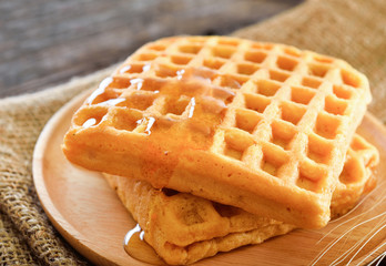 waffles honey syrup on wooden background