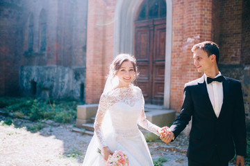 Married couple walking near the old beautiful castle