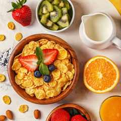 Healthy breakfast - bowl of corn flakes, berries and fruit