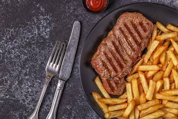 Beef barbecue steak with french fries.