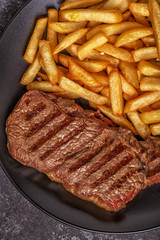Beef barbecue steak with french fries.
