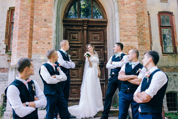 Beautiful bride with groomsmen