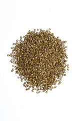 Plastic pellets gold purple on white background. Polymeric yellow dye. Colorant for plastics in the granules.