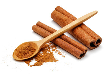 Cinnamon sticks and powder with wooden spoon