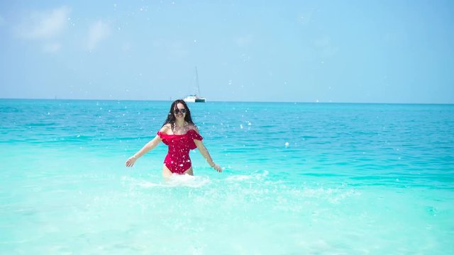 Young beautiful woman on the beach. Happy girl enjoy her tropical vacation exotic island