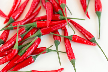 red hot chili peppers, popular spices concept - placer of beautiful red hot chili peppers, pods freely scattered on white background, top view, flat lay, isolated