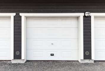 Naklejka na ściany i meble White garage wall with white closed gates