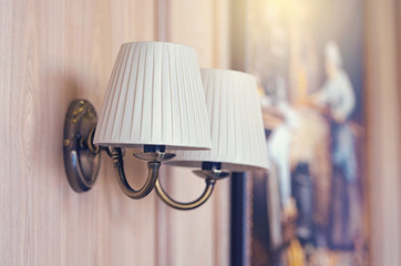 Interior of a living room, lamps on the wall