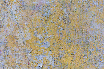 Colored old wall with abstract pattern, yellow vintage paint, background or texture
