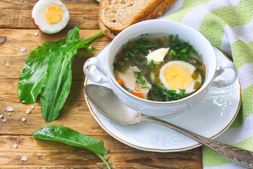 Sorrel soup in a white bowl