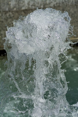 Fountain jet and water spray at sunny day.Splashes of water. 