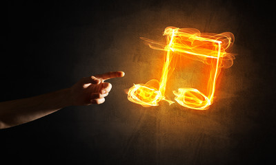 Music concept presented by fire burning icon and creation gesture