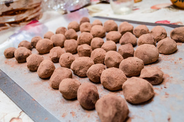 Tray of many homemade chocolate truffles closeup