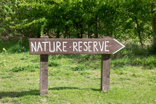 Rustic Sign For Nature Reserve In Field