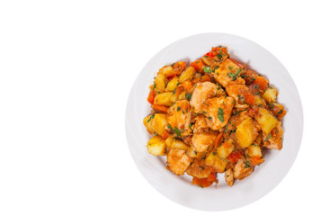 meat stew with potatoes, pepper, onion and carrot. top view. isolated on white