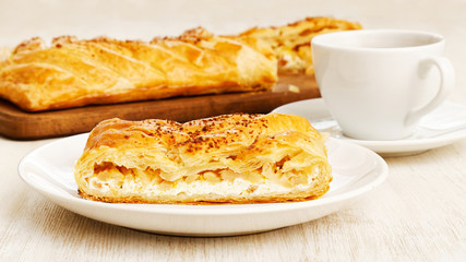 Homemade puff braided pie with cottage cheese, apples and raisin