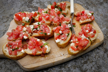 italian appetizer Bruschetta with tomato, herbs and goat cheese