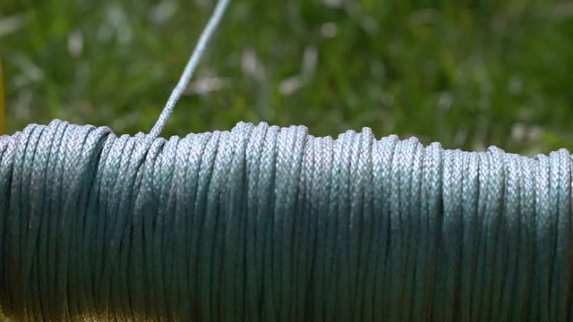In the frame there is a winch and a cable. The rope unwinds with great speed.