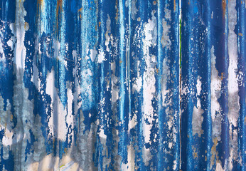 Urban background - old blue sheet metal with peeled blue color