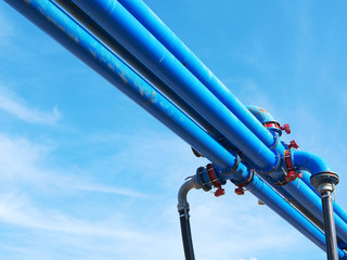 Blue water power tubes in front of blue sky