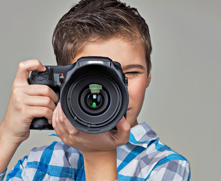 Boy with camera taking pictures.