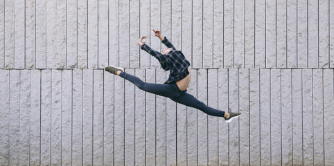 young male dancer performing a ballet jump