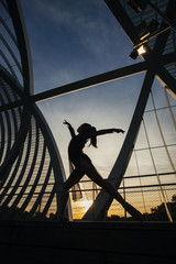 shape of a woman dancing classical ballet on bridge