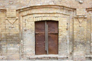 Boarded up and brick the Windows on old brick wall
