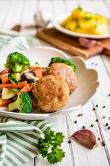 Fried pork burgers served with steamed vegetable