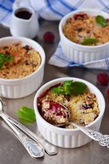 Crumble with berries, oatmeal and nuts on a metallic background