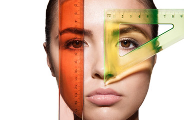 Close-up measure the woman's face and the shape of the eyes with rulers before the plastic surgery...