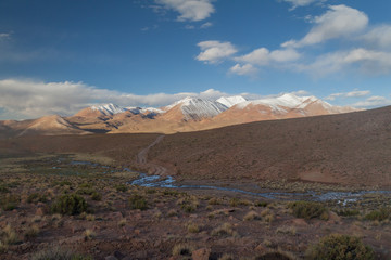 Snow covered mountains soaring from altiplano in Bolivia