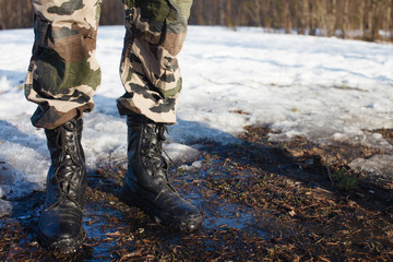 Fototapeta premium Dusty army boots on dirty ground