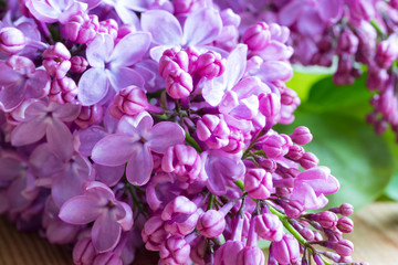 Fototapeta na wymiar Violet lilac flowers on a wooden table
