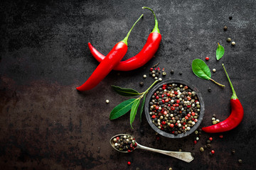Red hot chili pepeprs and peppercorns on black metal background, top view © Sea Wave