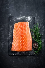 Selbstklebende Fototapeten Fisch Raw salmon filet on dark slate background, wild atlantic fish  © Sea Wave