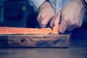Removing skin from salmon.