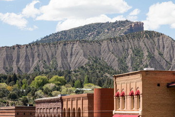 Brick buildings in downtown Durango, Colorado with Hogsback mountain and Perin's peak