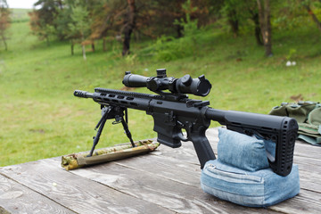 Sniper rifle. Horizontally. On the table in the forest.